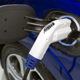 Blue electric car being charged