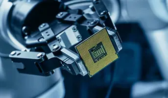Semiconductor chip being held by robotic arm